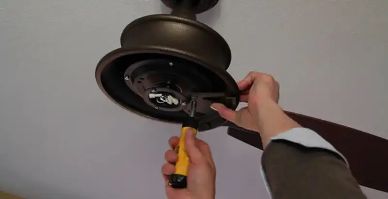Electrician installing ceiling fan mounting bracket and fixture in San Jose, CA