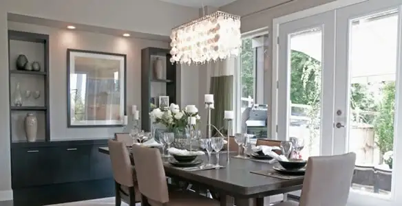 Elegant dining room chandelier installation above table in San Jose, CA