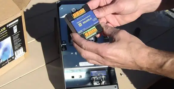Electrician installing whole home surge protection unit inside main electrical panel in San Jose, CA