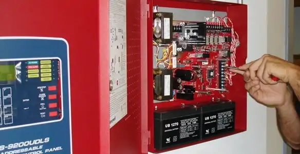 fire alarm installation service showing technician configuring fire alarm control panel in San Jose, CA