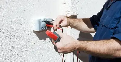 Electrician performing home electrical outlet and wiring inspection in San Jose, CA