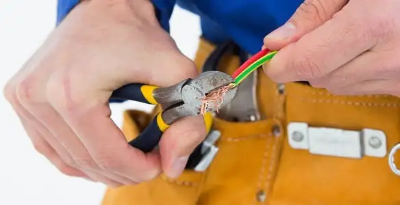 licensed electrician securing electrical wiring with professional tools during service work in San Jose, CA